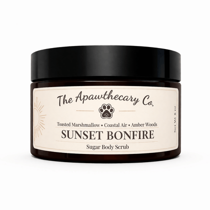 Sunset Bonfire Sugar Scrub jar by The Apawthecary Co., featuring toasted marshmallow and amber woods scents.
