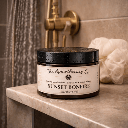 Sunset Bonfire Sugar Scrub in a luxurious bathroom setting with a soft shower loofah.