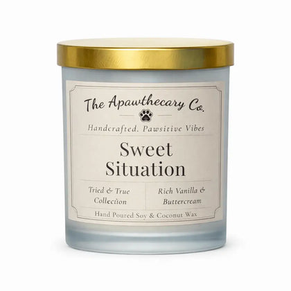 Candle with gold lid and 'The Apawthecary Co.' label on a white background