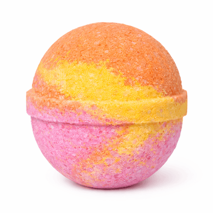 Colorful bath bomb with a gradient from orange to pink on a white background