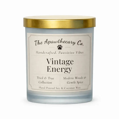 Candle with gold lid and 'The Apawthecary Co.' label on a white background