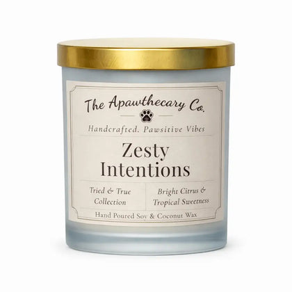 Candle with gold lid and label from The Apawthecary Co. on a white background
